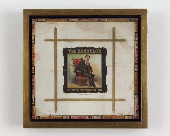 Framed collage made of various items, with an image in the center of a figure seated in a red chair smoking a cigar, with text surrounding the image that reads &quot;The Bachelor&quot; and &quot;Victor Thorsch Co.&quot;