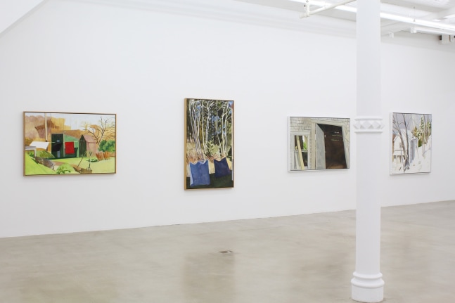 Photograph showing a view of an exhibition space, with four paintings hanging on a white wall