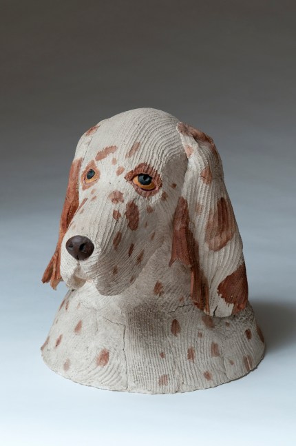 Sculpture of the head of a white dog with brown spots