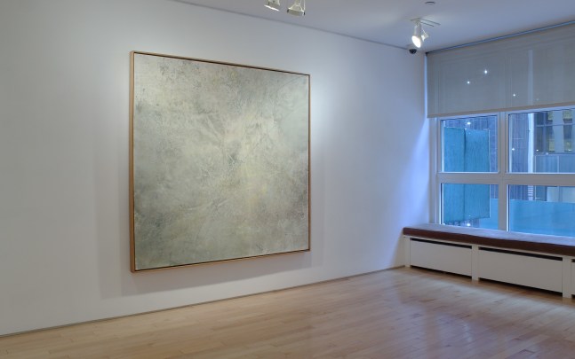 Photograph showing a view of an exhibition space, with one large painting hung on a white wall