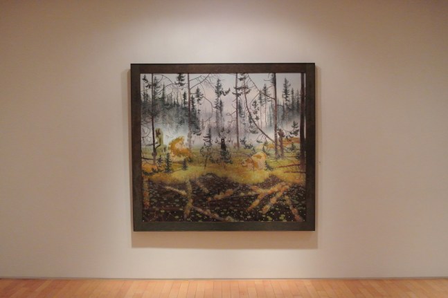 Photograph showing a view of an exhibition with one large framed painting hanging on a white wall