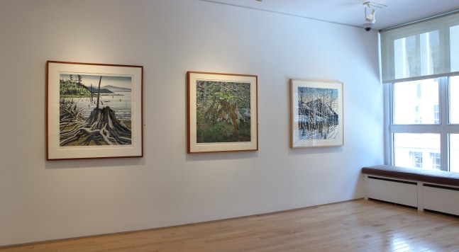 Photograph showing a view of an exhibition space, with three painting hanging on a white wall