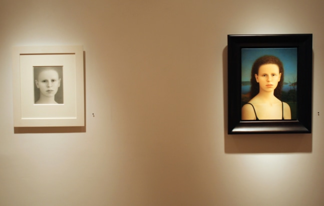 Photograph showing a view of an exhibition space, with one small framed drawing a one small framed painting hanging on a white wall