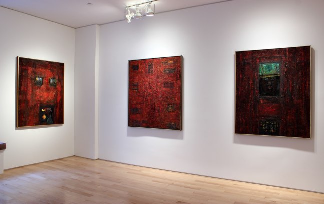 Photograph showing a corner view of an exhibition space, with three paintings hanging on white walls