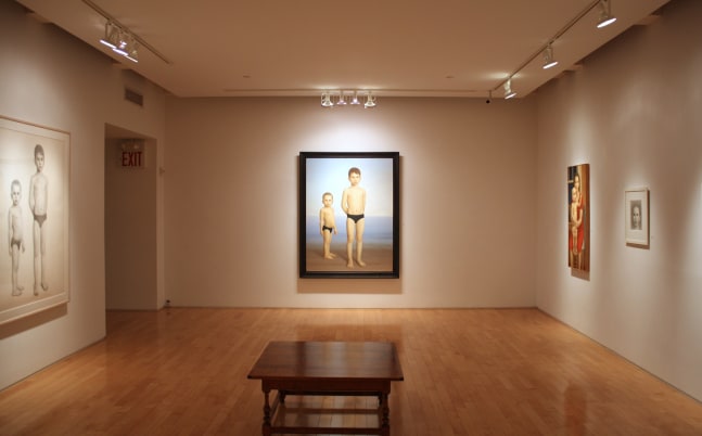 Photograph showing a corner view of an exhibition space, with two large framed paintings, a large framed drawing and a small framed drawing hanging on white walls
