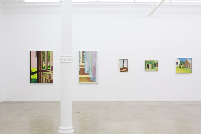 Photograph showing a view of an exhibition space, with five paintings hanging on a white wall