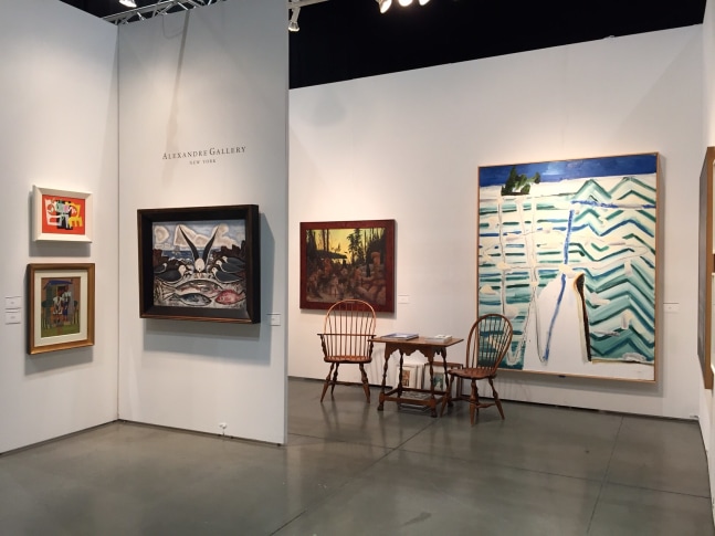 Photograph showing a view of an exhibition space, with five paintings of various sizes hanging on white walls