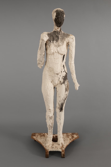 An image of a Manuel Neri sculpture of a Standing Female Figure, made in 1987 from plaster, burlap, acrylic, wood, styrofoam, and steel.  Its dimensions are  70 3/4 x 26 1/4 x 17 1/2 inches.