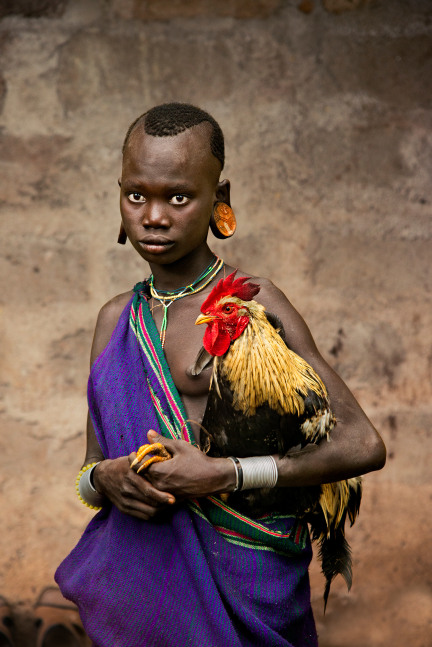 Steve McCurry  Kara Woman Holds Rooster, Omo Valley, Ethiopia
