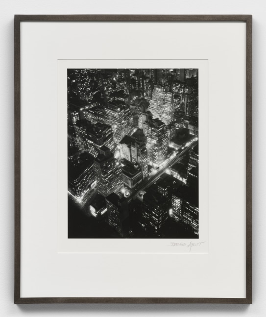 A black and white Berenice Abbott photographic print of New York City at night from high up
