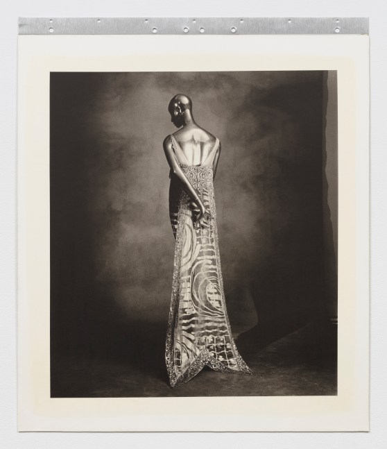 Black and white photographic portrait of the back of a woman's ornate dress.