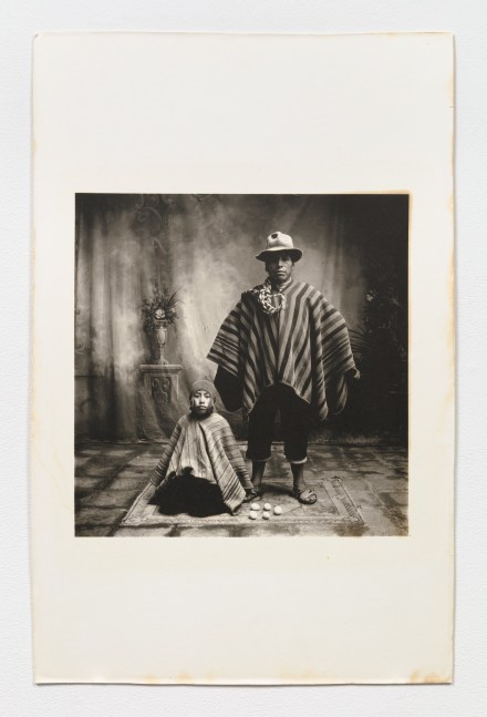 Black and white photographic double portrait of father and son with eggs.