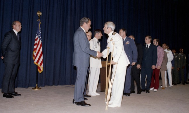 President Nixon greets former POW US Navy Lieutenant Commander John McCain at a pre-POW dinner reception at the White House, Washington D.C., 1973 (Courtesy National Archives)