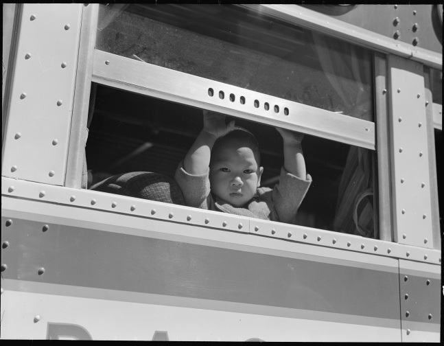 Young Japanese American boy en route to Tanforan Assembly Center, San Francisco, California, April 29, 1942 (Courtesy National Archives)