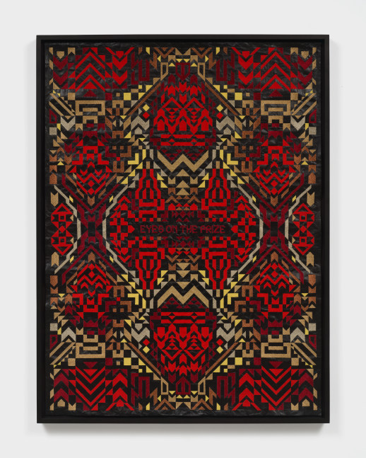 A framed artwork with red and yellow embroidered patterns on black roofing material with &quot;Eyes on the Prize&quot; in the center.