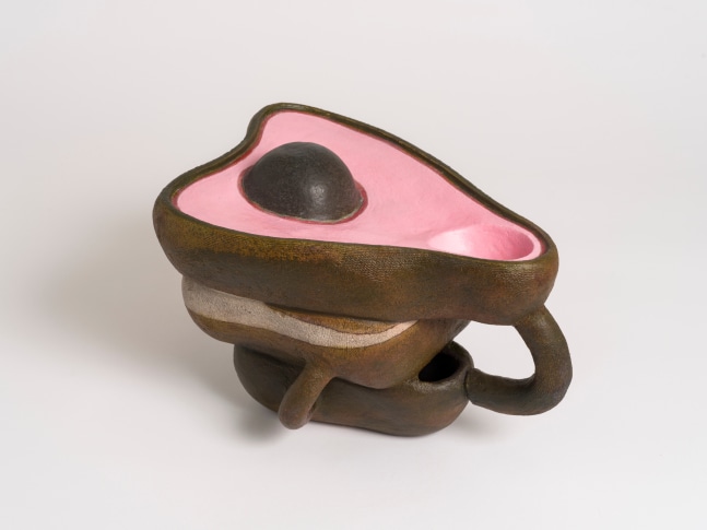 A ceramic sculpture by Brad Eberhard of a pink and brown avocado like form.