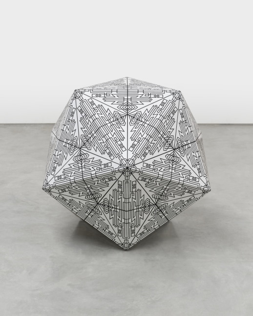 A white octagonal sculpture with intricate black patterns on the surface.