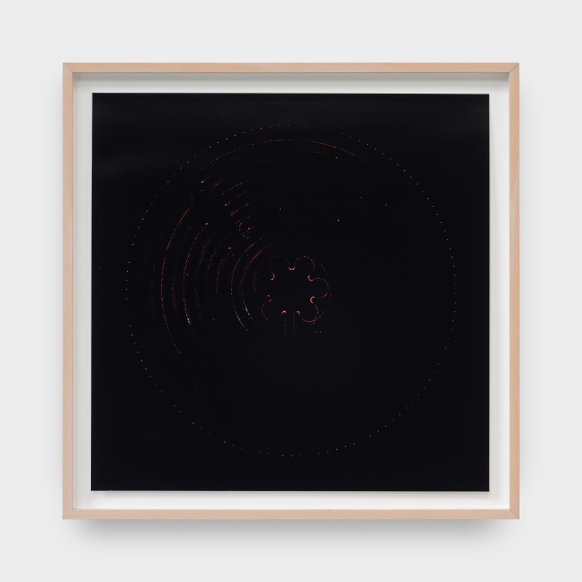 A framed artwork by Laura Howard Parker of black pigment with rounded and floral shapes scratched into the paper.