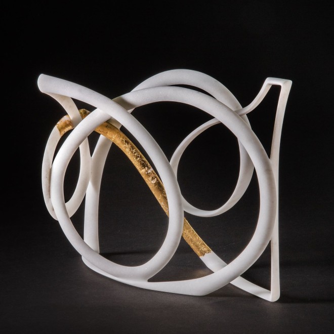 a sculpture by Elizabeth Turk of a thin looping bands of marble, a corner of which is covered in gold leaf
