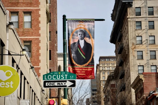 A banner designed by Xenobia Bailey hangs at the corner of 13th and Locust streets near the Pennsylvania Historical Society. (Emma Lee/WHYY)