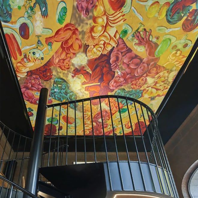 Interior view of Brutalisten, featuring Ana Benaroya's painting on the ceiling