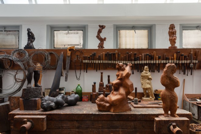 Photo by Elizabeth Felicella showing Chaim Gross's workbench, tools, and finished sculptures in the studio. 