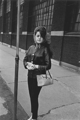 Woman outside a tire factory waiting for the bus, Detroit, 1968