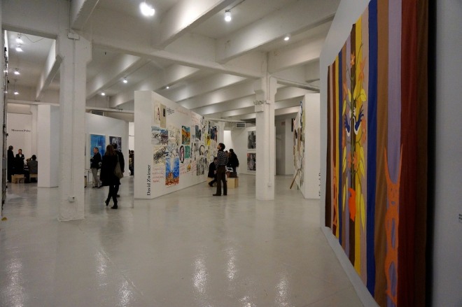 A view of Independent Projects, with a felt banner by Mike Kelley on the right and David Zwirner&rsquo;s booth of Raymond Pettibon in the center back (all photos by the author for Hyperallergic)