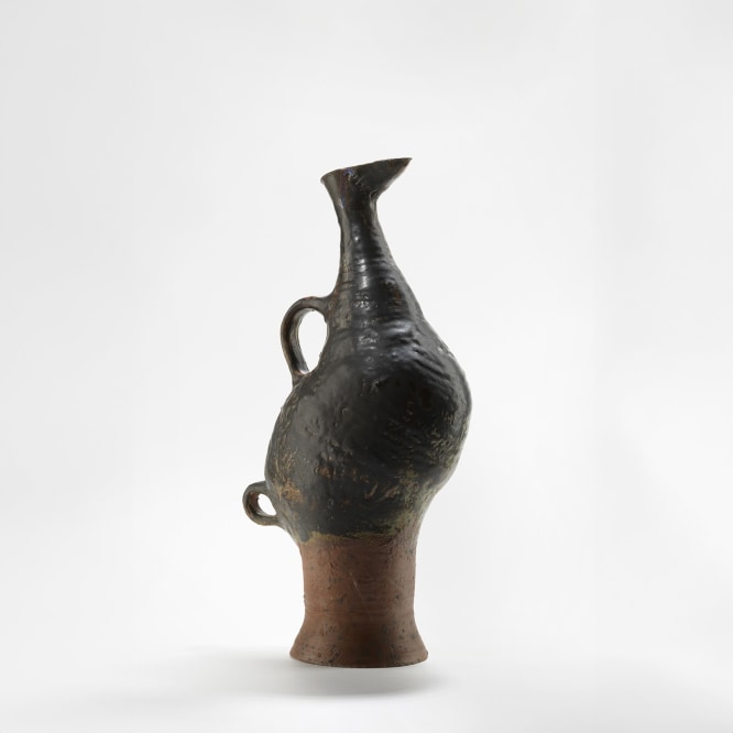 photograph of a zoomorphic bird jug in an empty room