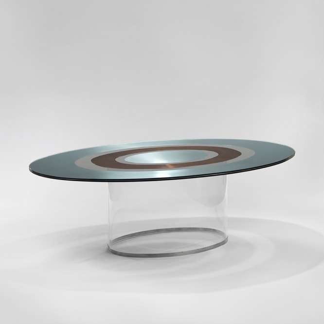 picture of a table with glass base in a gray room 