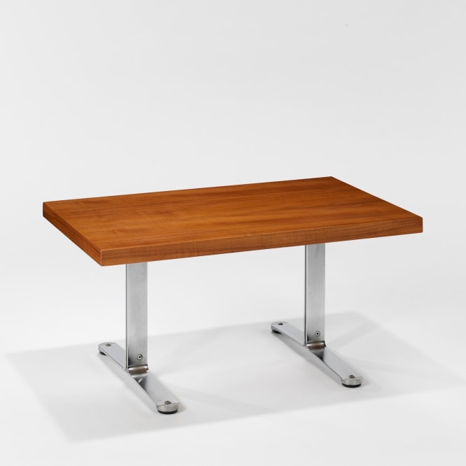 photograph in blank room with table by Tallon made with teak wood top and steel and metal legs