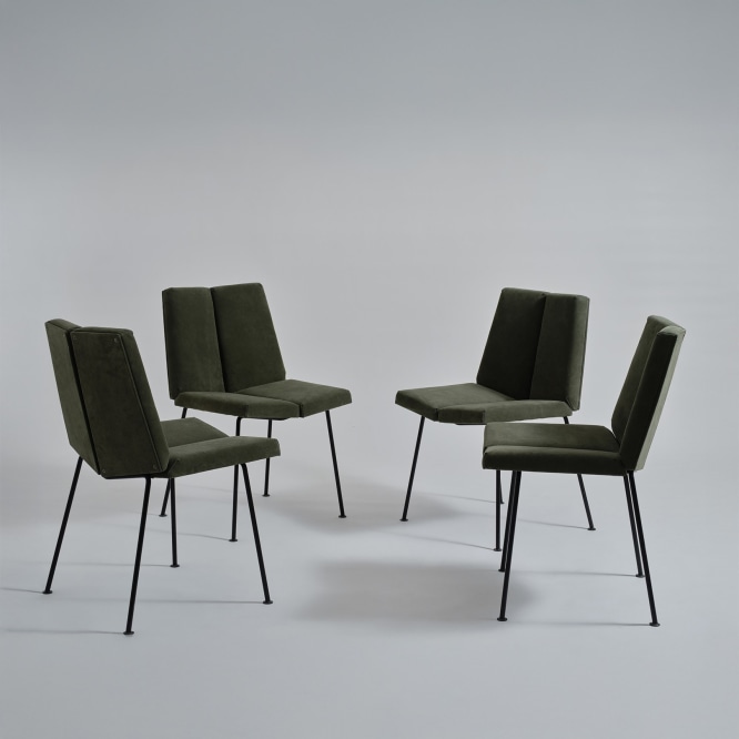 set of four chairs in an empty room