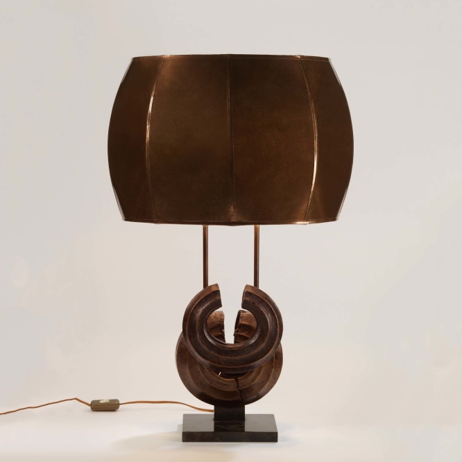 photograph of a brown lamp in a white room with two overlapping circles at its base