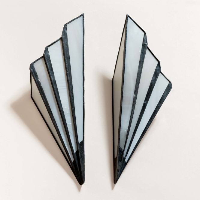 pair of art deco sconces on a wall