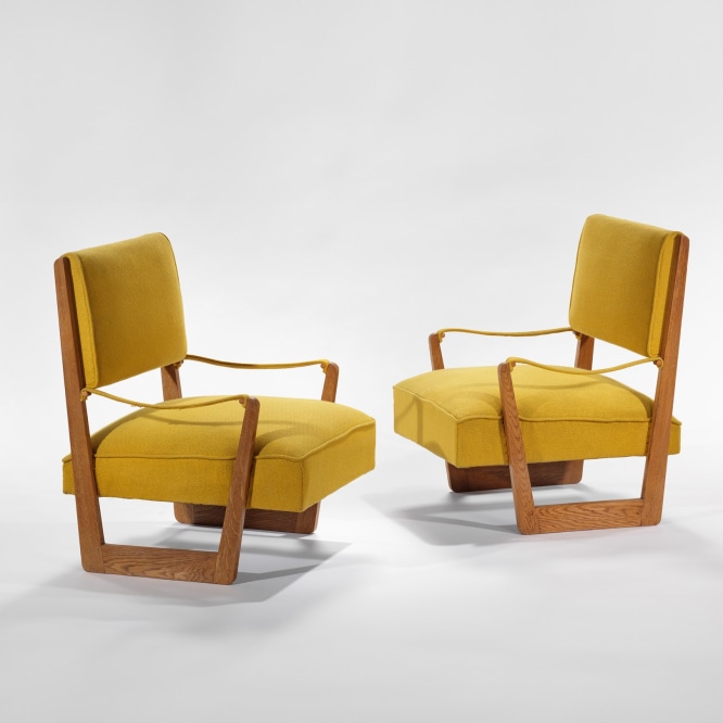 yellow and wood armchairs in an empty room