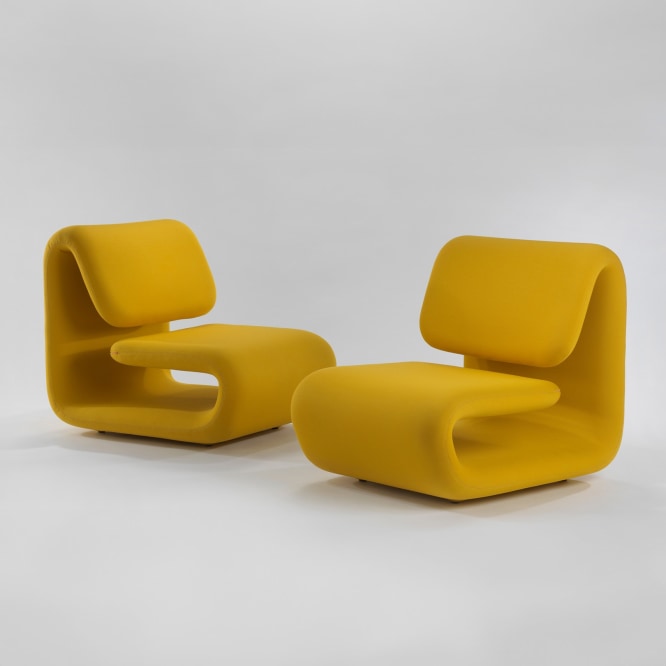 pair of yellow chairs in a blank room