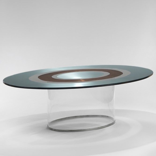 picture of a table with glass base in a gray room 