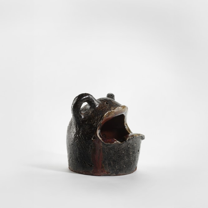 photograph of a zoomorphic frog bowl in an empty room