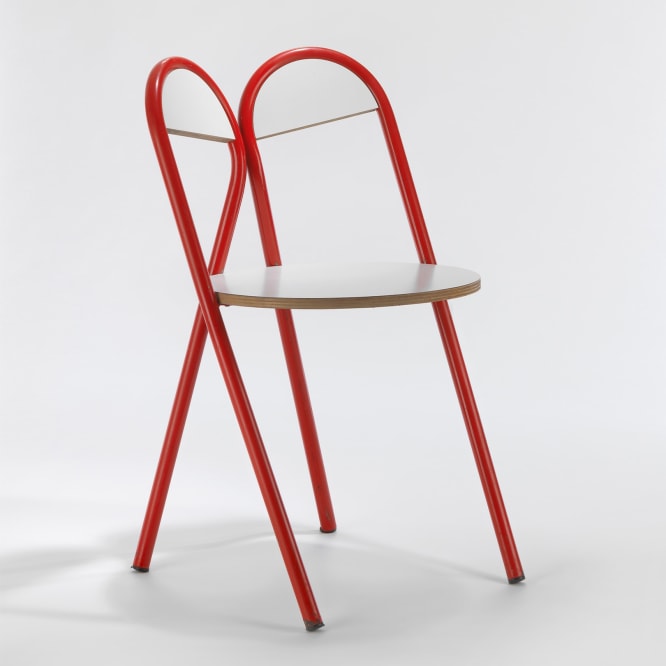 red and white tubular chair in a blank room