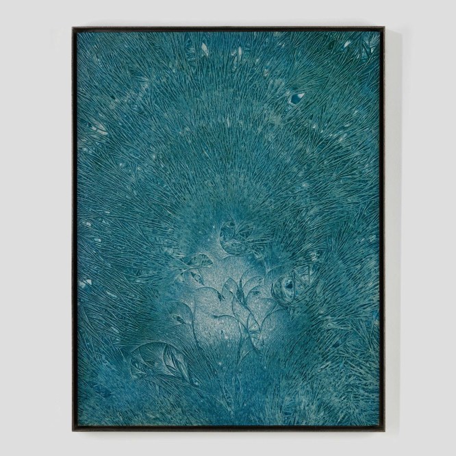 photograph of a turquoise artwork on a white wall