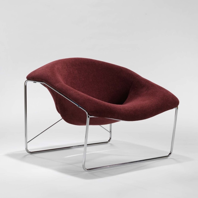 photograph of chair in a blank room with metal legs wine red upholstery 