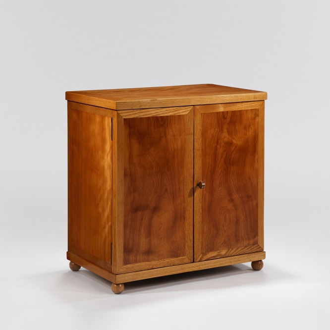 Wooden cabinet with rounded feet and brass pull