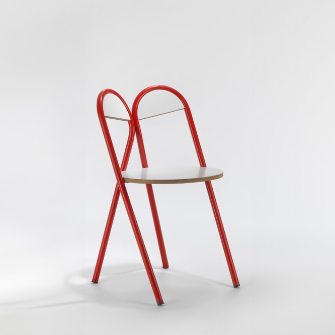 red and white tubular chair in a blank room