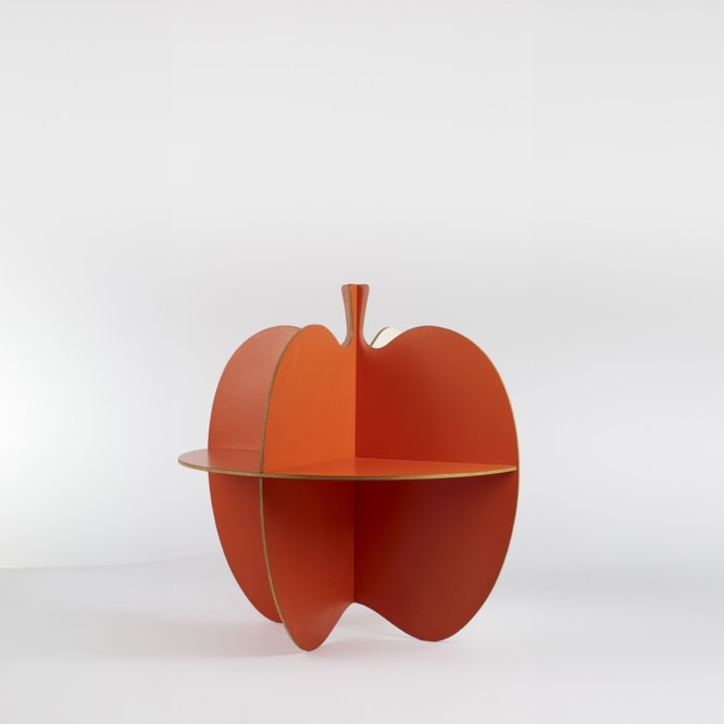 picture of a table that is shaped like an apple in an empty room