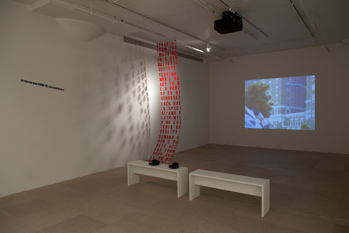Tony Conrad Studio of the Streets, 1990-1993 Compilation of four digitized videos, acrylic panel, and vinyl lettering Dimensions variable; Panel: 144 x 26 inches (365.8 x 66 cm)