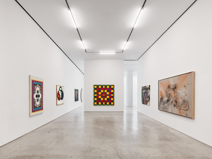 Installation view of "Schema World as Diagram" featuring several paintings in a white space.