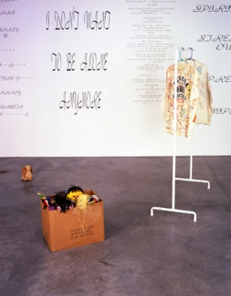 Mike Kelley, Written in the Wind, 1991 (Detail). Cardboard box, 10 found stuffed animals, coat rack with jacket & shirt, ten wall texts, dimensions variable. MP 9180