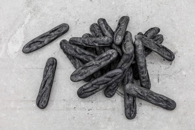 Man, 2017. Burnt baguettes, Dimensions variable.