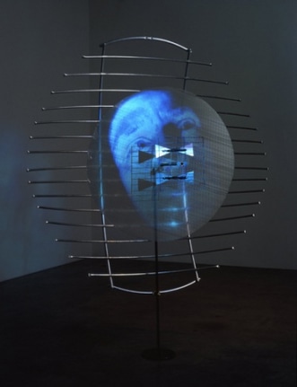 Buzz, 2001. Sony DPL CS2 projector, DVD player, DVD, metal, plastic, Performance by: Joe Gibbons, 104 x 84 x 36 inches + equipment. MP 314