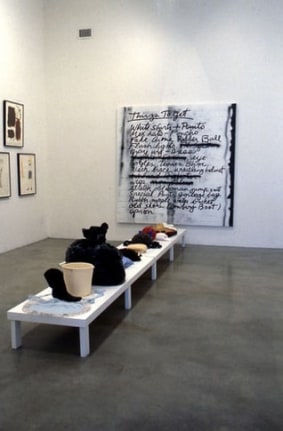 Mike Kelley and Tony Oursler, Things to Get, 1997. Found objects on wood platform, spray paint, enamel paint on canvas; platform: 12 x 25-3/8 x 162 inches, painting: 84 x 83 inches. MP 1